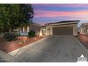 Well-maintained home with a two-car garage and attractive desert landscaping at 13766 W Junipero Dr, Sun City West, AZ 85375