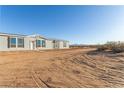 Single-story home with light gray siding, and a large yard at 50815 W Saffron Ln, Maricopa, AZ 85139