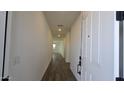 Bright hallway with wood-look tile flooring leading into the home at 37907 N Cowboy Ln, San Tan Valley, AZ 85140