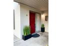 Red front door entry with modern landscaping and potted plants at 4131 E Camelback Rd # 29, Phoenix, AZ 85018