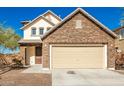 Two-story house with stone accents and a two-car garage at 29280 W Weldon Ave, Buckeye, AZ 85396