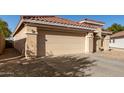 Tan house with a two-car garage and desert landscaping at 5014 S 26Th Ln, Phoenix, AZ 85041