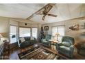 Cozy living room with wood floors, comfy seating and a Christmas tree at 9333 E University Dr # 177, Mesa, AZ 85207