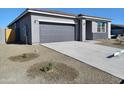 One story home with gray exterior and two car garage at 24078 W Pecan Rd, Buckeye, AZ 85326