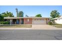 Single-story home with brick facade and attached garage at 10861 W Venturi Dr, Sun City, AZ 85351