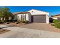 Single-story home with a two-car garage and well-manicured landscaping at 10308 E Tahoe Ave, Mesa, AZ 85212