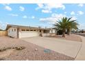 House exterior with palm tree and gravel driveway at 11002 W Deanne Dr, Sun City, AZ 85351