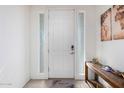 Bright entryway with a white door and wood console table at 6745 N 93Rd Ave # 1170, Glendale, AZ 85305