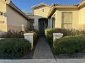 Front entry with decorative wrought iron door and manicured landscaping at 6216 W Hedgehog Pl, Phoenix, AZ 85083