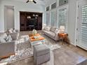 Spacious living room with built-in shelving, large windows, and comfortable seating at 12446 W Bajada Rd, Peoria, AZ 85383