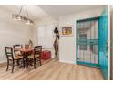 Bright dining area with a wooden table and chairs, near the entrance at 14950 W Mountain View Blvd # 4205, Surprise, AZ 85374