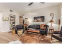 Living room with leather sofa, chairs, and a cowhide rug at 14950 W Mountain View Blvd # 4205, Surprise, AZ 85374