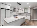 Modern kitchen with white cabinets, hexagon tile, and an island at 1718 E Campbell Ave # 51, Phoenix, AZ 85016