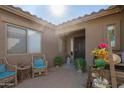 Charming front patio with seating area, creating a welcoming entryway at 6918 S 252Nd Dr, Buckeye, AZ 85326