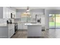 Updated kitchen with white cabinets and quartz countertops at 4302 N 80Th Ln, Phoenix, AZ 85033