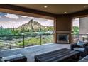 Covered patio with mountain views and fireplace at 27000 N Alma School Pkwy # 2004, Scottsdale, AZ 85262