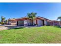 Single-story home with front yard, driveway, and a landscaped lawn at 11107 E Wier Ave, Mesa, AZ 85208