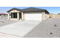 One-story home with light beige exterior and gravel yard at 201 S Apache Ave, Eloy, AZ 85131
