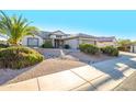 Single story home with attached two car garage and desert landscaping at 18483 N Deer Grass Ct, Surprise, AZ 85374