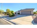 Single story home with attached two car garage and desert landscaping at 18483 N Deer Grass Ct, Surprise, AZ 85374