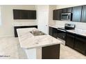 Modern kitchen with dark cabinets and marble countertops at 1988 W Cameron Blvd, Coolidge, AZ 85128