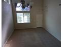 Bright entryway with tile and carpeted floors, featuring a stained-glass window and a neutral color palette at 13510 W Merrell St, Avondale, AZ 85392