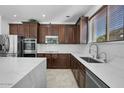 Spacious kitchen with dark wood cabinets, quartz countertops, and stainless steel appliances at 3535 E Melody Ln, Gilbert, AZ 85234