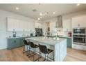 Modern kitchen with green cabinets, large island, and stainless steel appliances at 22689 E Bonanza Way, Queen Creek, AZ 85142