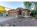 Well-maintained single-story home with landscaping at 813 E Lovegrass Dr, San Tan Valley, AZ 85143