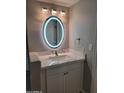 Bathroom with an illuminated oval mirror and vanity at 1942 S Emerson -- # 131, Mesa, AZ 85210