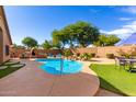 Escape to this private backyard with a sparkling pool and a relaxing waterfall feature at 30118 N Maravilla Dr, San Tan Valley, AZ 85143