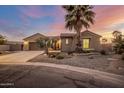 Tan two-story house with a three-car garage and desert landscaping at 4675 N Bryce Canyon Ct, Eloy, AZ 85131