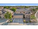 Two-story house with a three-car garage and mountain views at 9237 W Alex Ave, Peoria, AZ 85382