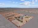 Aerial view of a large property with equestrian facilities and a main house at 32614 N 227Th Ave, Wittmann, AZ 85361