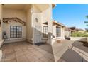 Front entrance of a house with tiled patio and wrought iron door at 2720 Leisure World --, Mesa, AZ 85206