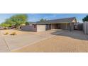 Single-story home with carport and modern brick facade at 3033 E Sierra St, Phoenix, AZ 85028