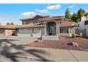 Two-story house with three-car garage and landscaped front yard at 19537 N 69Th Ave, Glendale, AZ 85308