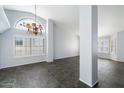 Bright living room featuring a stained-glass window and tile floors at 19537 N 69Th Ave, Glendale, AZ 85308