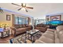 Living room with two sofas, coffee table, and large aquarium at 18903 N 97Th Ln, Peoria, AZ 85382