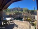 Relaxing backyard patio with a spa, seating area, and mountain views at 27440 N Alma School Pkwy # 116, Scottsdale, AZ 85262