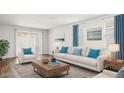 Bright living room featuring a comfortable sofa and coffee table at 25383 W Sunland Ave, Buckeye, AZ 85326