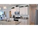 Modern kitchen with white cabinets and granite countertops at 3722 E Haflinger Rd, San Tan Valley, AZ 85140