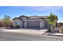 Single-story house with three-car garage and brick driveway at 1619 E Joelle Dr, Casa Grande, AZ 85122