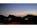 Night view of city lights nestled in the mountains at 10722 N Skyline Dr, Fountain Hills, AZ 85268