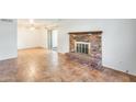 Living room with a brick fireplace and tile flooring at 222 W Brown Rd # 117, Mesa, AZ 85201