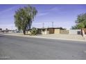 Tan single story home with mature tree and cactus plants at 694 W Coolidge Pl, Coolidge, AZ 85128