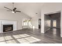 Bright living room featuring hardwood floors, a fireplace, and ample natural light at 7526 W Sweetwater Ave, Peoria, AZ 85381