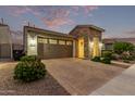 View of the home's exterior at dusk at 10553 E Relativity Ave, Mesa, AZ 85212