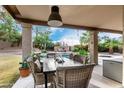 Patio dining area with pool view at 1201 E Le Marche Ave, Phoenix, AZ 85022