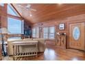 Living room with vaulted ceiling, wood walls, and large windows at 28216 N 148Th St, Scottsdale, AZ 85262